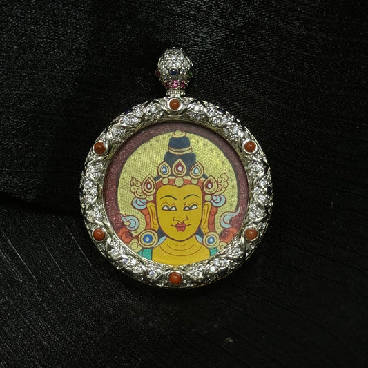 Round Manjushri Bodhisattva mini thangka pendant with jeweled copper frame, hand-painted mineral pigment portrait on red background in Rebgong Tibetan style.