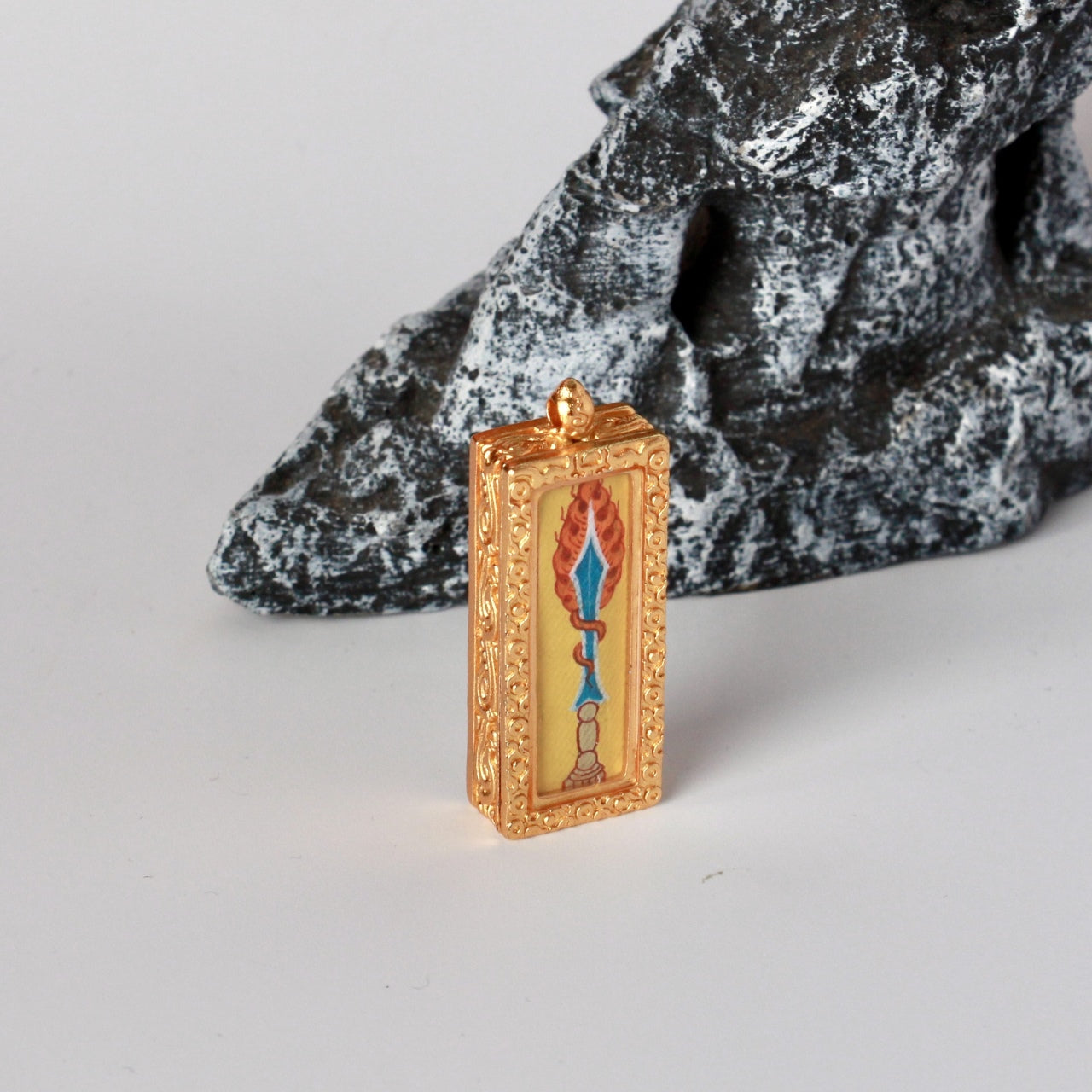 Side profile of the Manjushri Wisdom Sword mini thangka pendant highlighting the handcrafted copper frame and fine edge finishing.