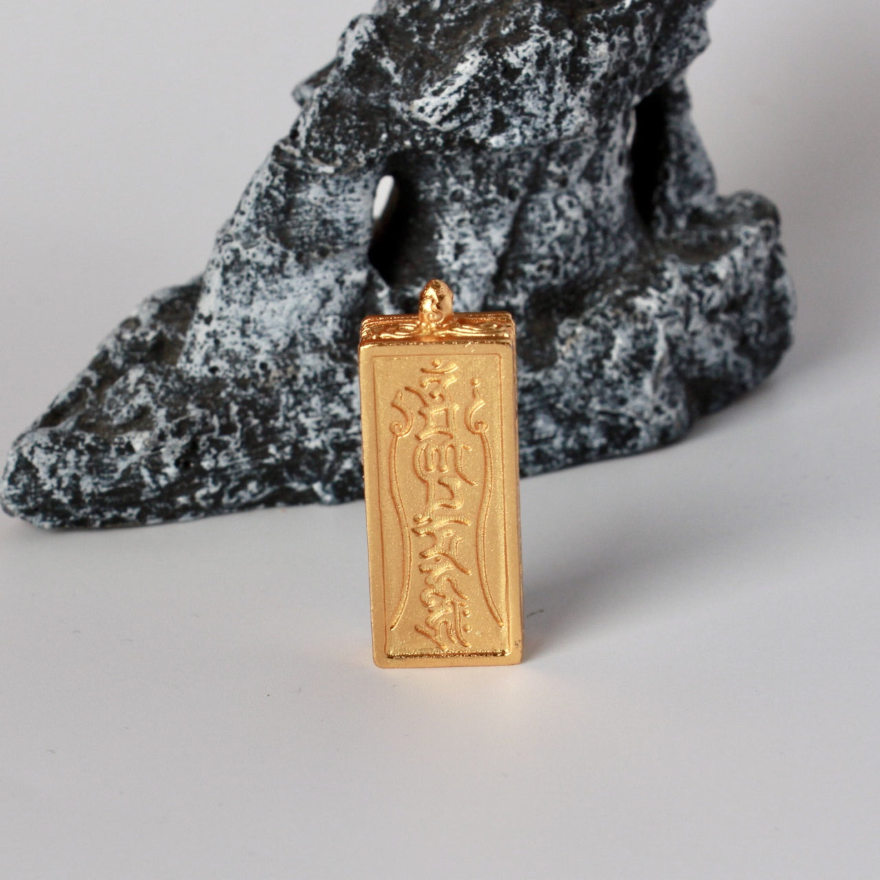 Back view of the Manjushri Wisdom Sword mini thangka pendant featuring engraved Tibetan mantra on the copper back plate.