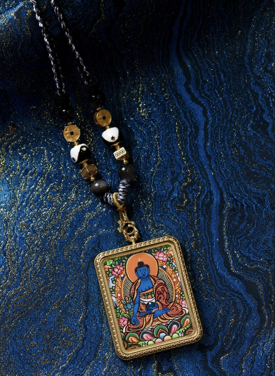 Detail view of Nepalese Color Thangka Medicine Buddha pendant showing mineral pigment painting, lotus base, bead accents, and titanium steel frame