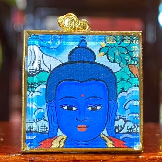 Front view of Medicine Buddha (Bhaisajyaguru) Tibetan mini thangka pendant, 18K gold double-sided hand-painted in Rebgong tradition