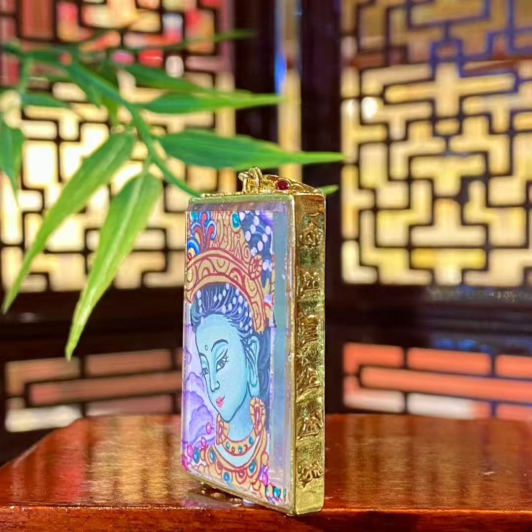 Side view of a mini Green Tara Gau Thangka pendant highlighting the slim copper gau box design suitable for daily wear and portability