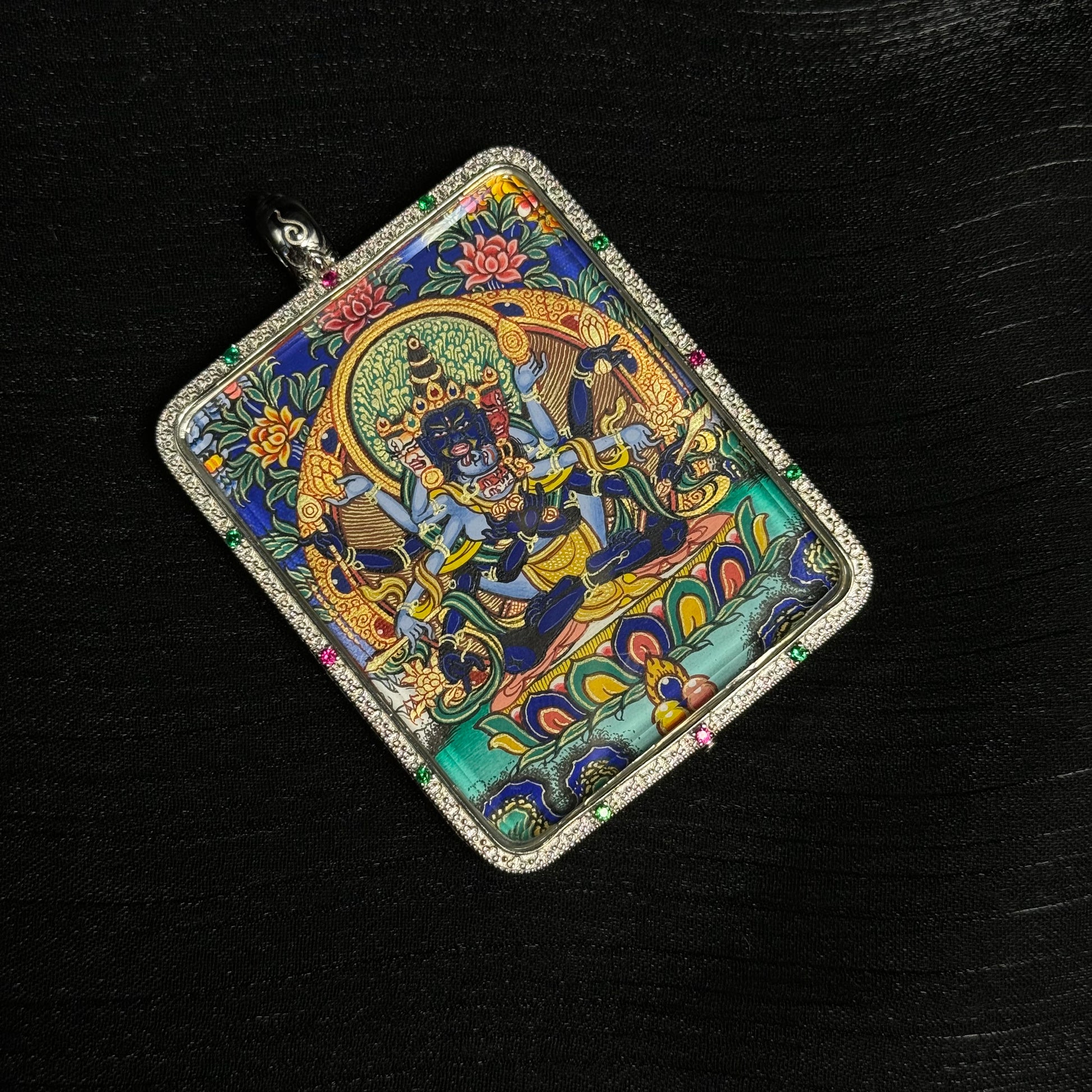 Miniature Guhyasamaja Vajra thangka pendant in sterling silver case, detailed Tibetan sacred artwork with gold and mineral pigments.