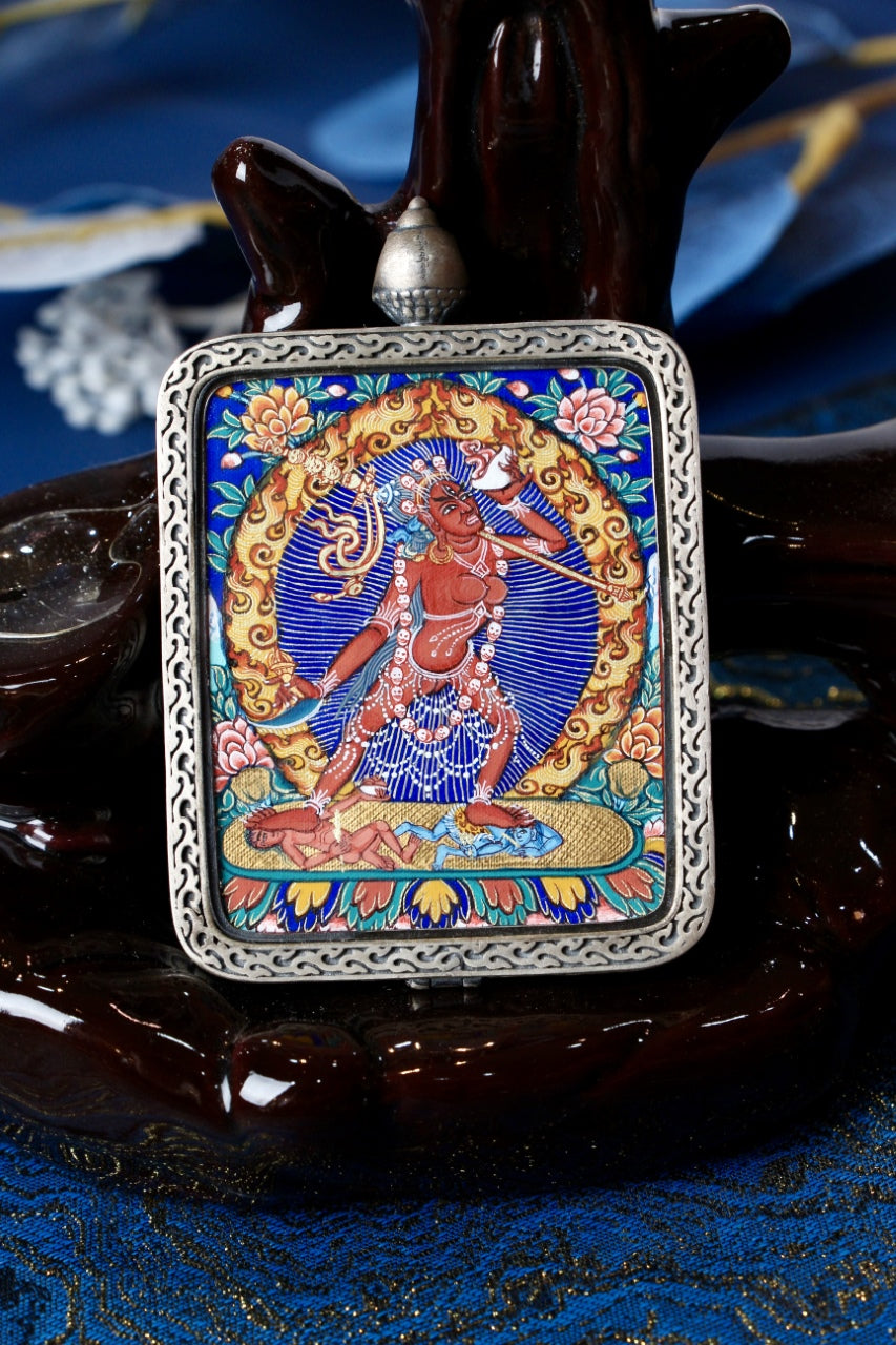 Front view of Naro Khechari Dakini mini thangka pendant, hand-painted with mineral pigments in Rebgong tradition, set in a silver gawu case