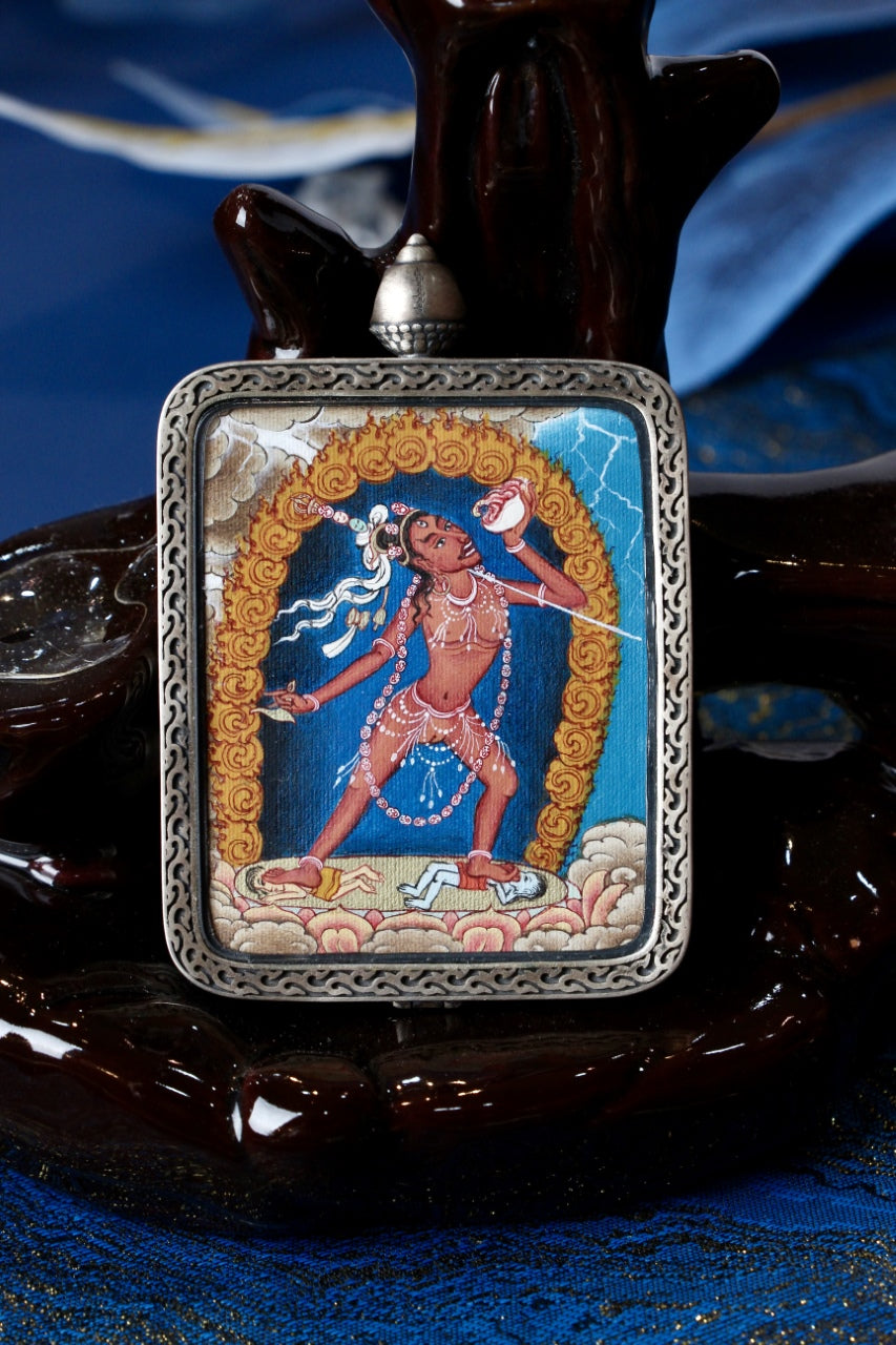 Front view of Naro Khechari Dakini mini thangka pendant, hand-painted with mineral pigments in Tibetan tradition, set in a silver gawu case
