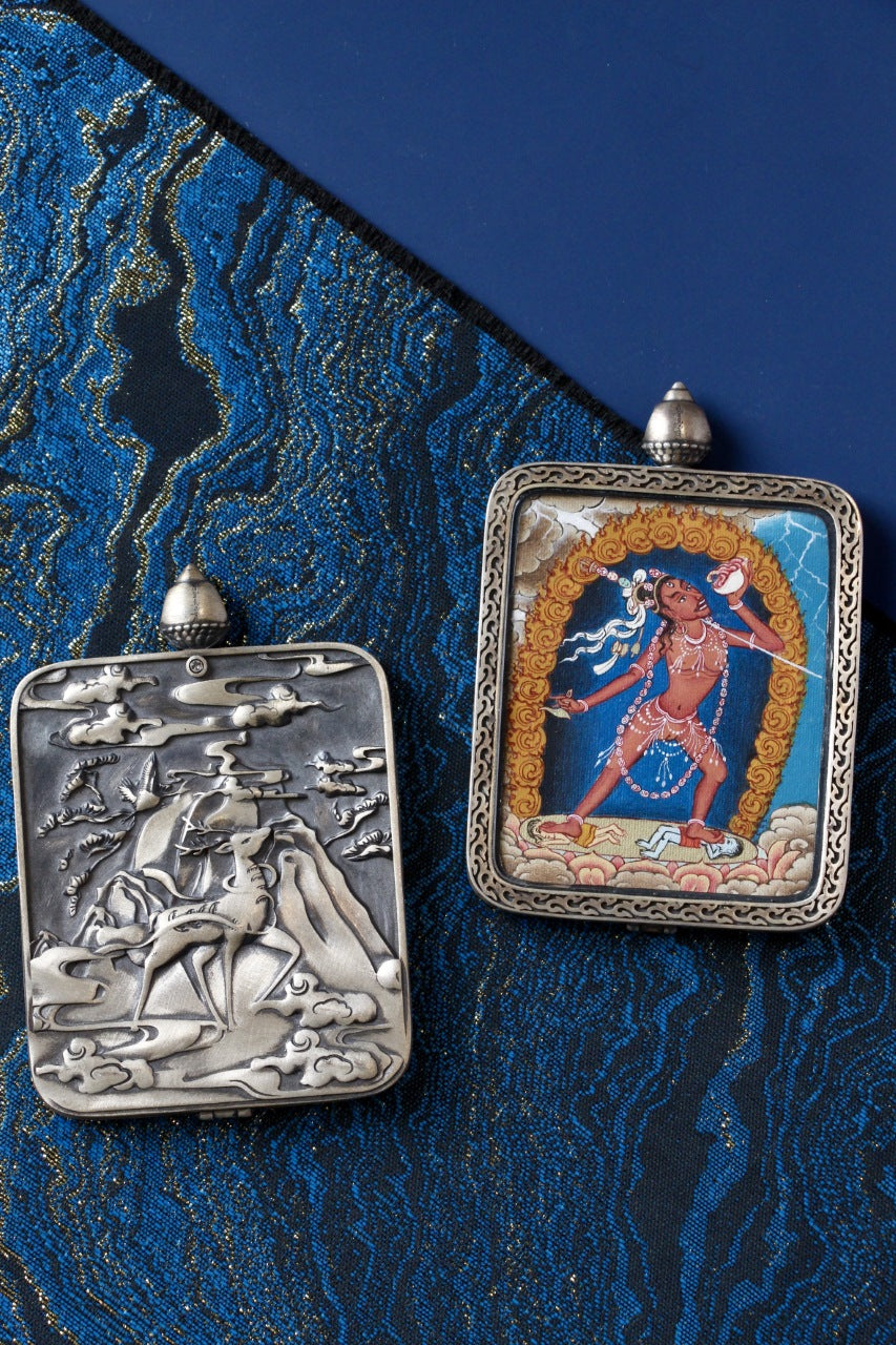 Naro Khechari Dakini mini thangka pendant shown with its silver gawu case, highlighting hand-crafted metalwork and traditional thangka format