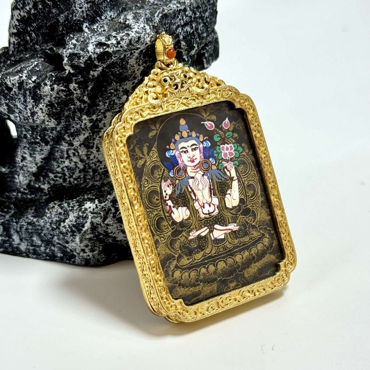 Close angled view of the pendant bail and top crown structure on the Nepal Black Gold Series frame, with detailed carving and a warm gold-toned finish.