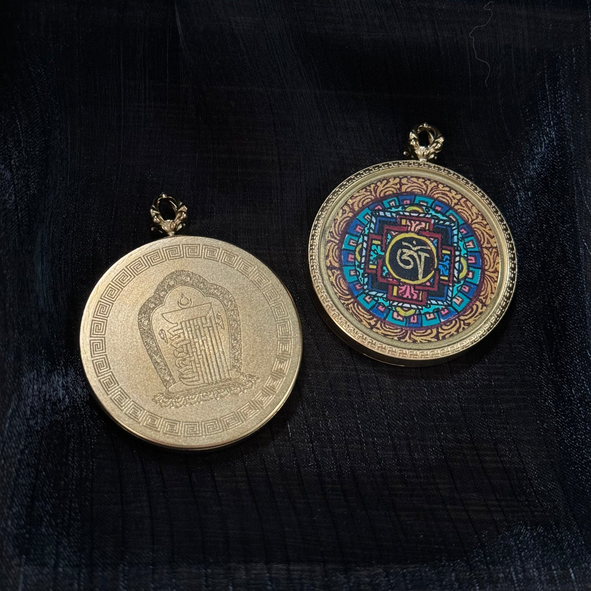 Front and back view of Nepal mandala miniature thangka pendant showing hand-painted mandala design and engraved sacred symbol on the reverse side