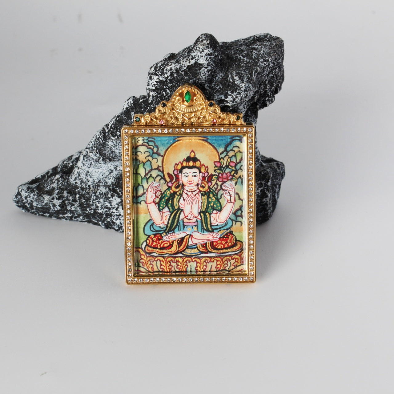 Front view of Nepal pastel-style Four-Armed Avalokiteshvara (Chenrezig) mini thangka pendant in a jeweled double-sided titanium steel case, size 4×5.