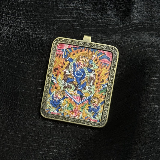 Close-up of Simhamukha Dakini thangka pendant displaying lion-faced dakini iconography, flaming aureole, and intricate mineral pigment brushwork inside a copper frame