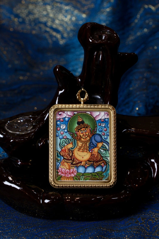 Hand-painted Nepalese Color Thangka Yellow Jambhala pendant displayed in a titanium steel frame, featuring traditional Himalayan Buddhist iconography