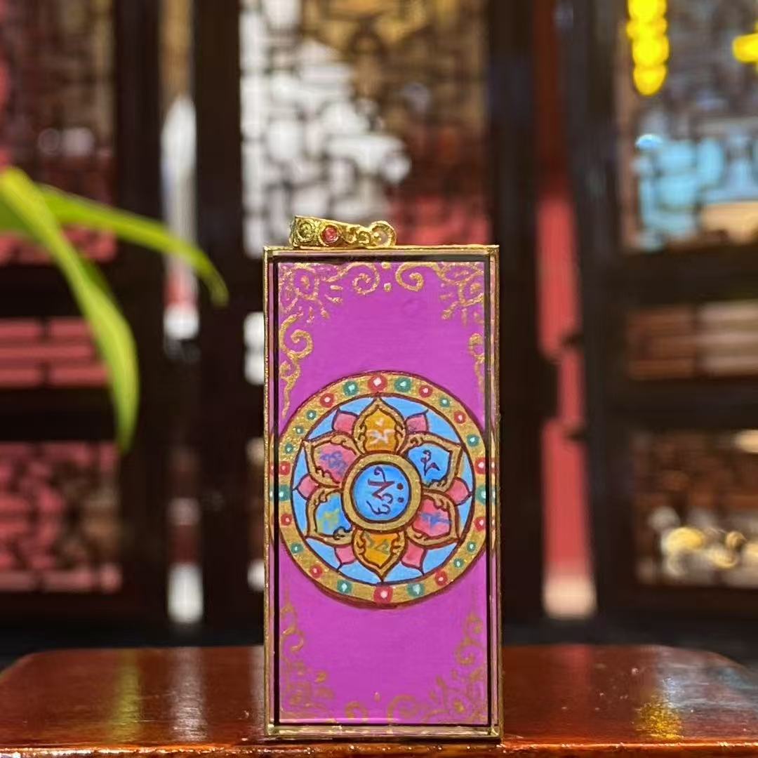 Back view of double-sided thangka pendant featuring Om Mani Padme Hum mantra hand-painted in 18K gold