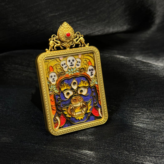 Angled front view of a Palden Lhamo mini thangka pendant showing the 24K gold-plated copper case, raised cloisonné enamel details, and vivid multicolor surface.
