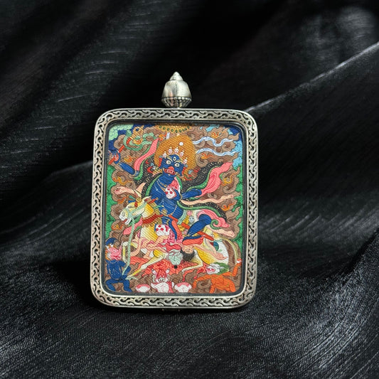 Front view of a Palden Lhamo mini thangka pendant featuring hand-painted mineral pigments, gold powder details, and a decorative metal pendant frame.