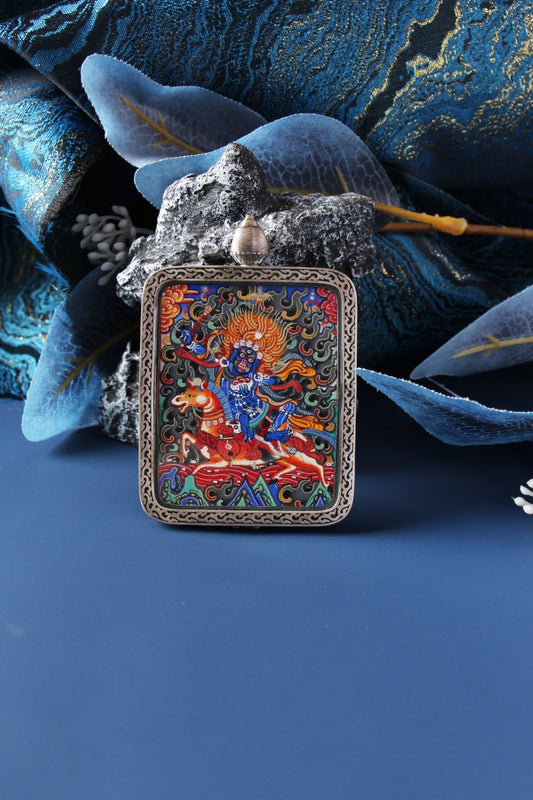 Close-up of a Palden Lhamo (Shri Devi) thangka pendant, hand-painted in Rebgong style with natural mineral pigments and gold powder, set in a 925 silver case.
