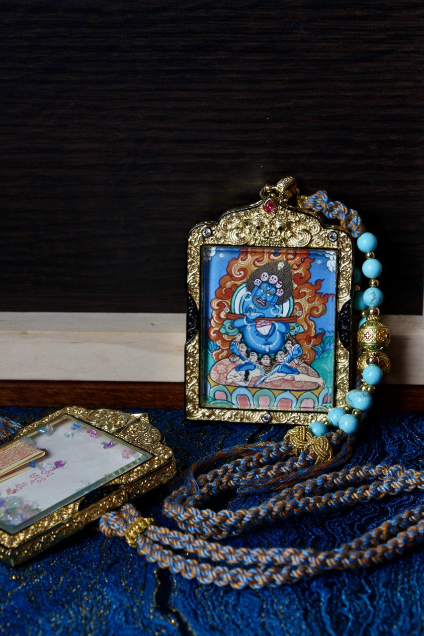 Front view of Rebgong Baizhang Mahakala thangka pendant, double-sided hand-painted on mineral pigments, set in black-gold copper gawu frame, painting size 4 × 5 cm