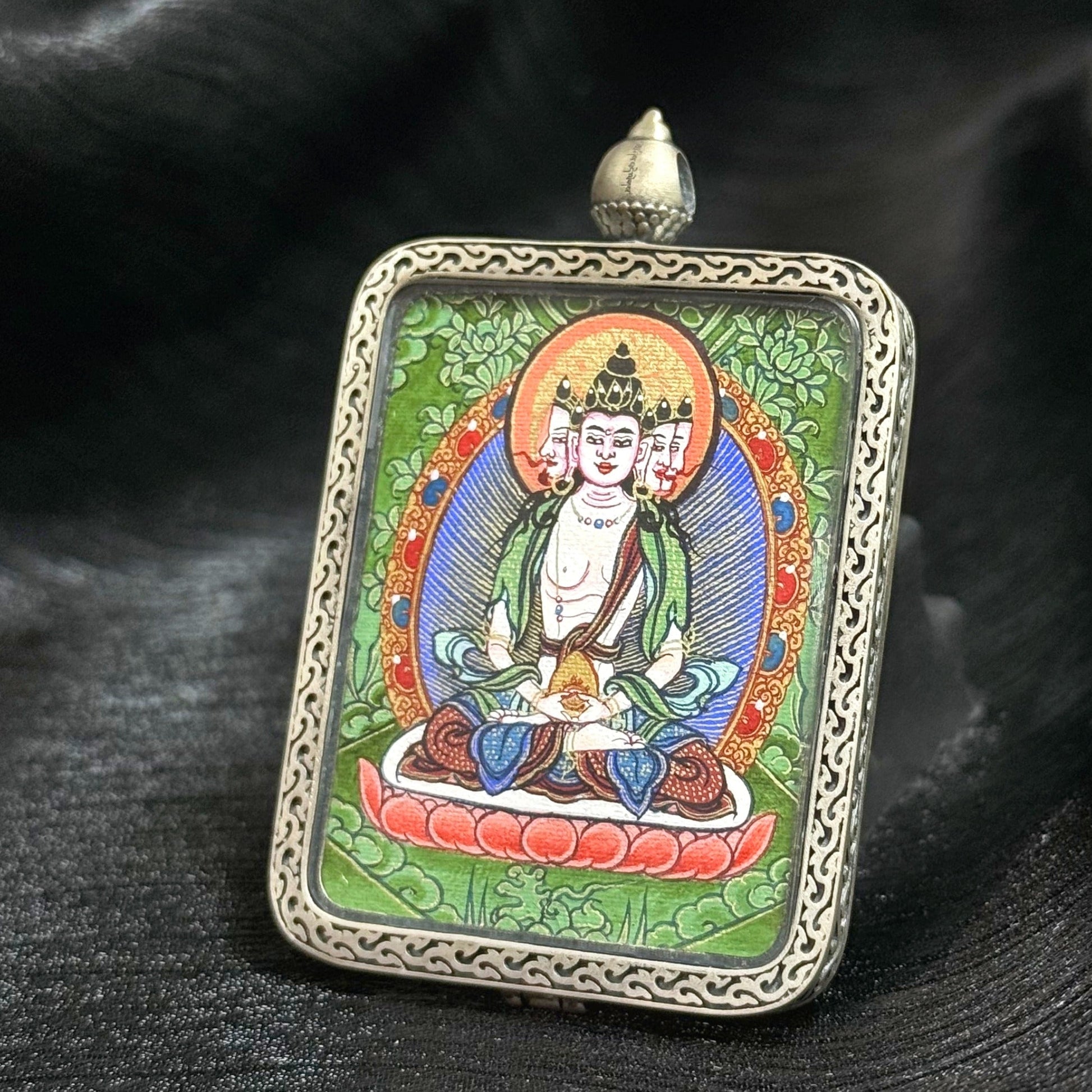 Close-up of Rebgong Cui Thangka painting showing layered mineral green and lapis-blue tones with gold powder cosmic patterns, representing Dharmadhatu wisdom in Vairocana Buddha art