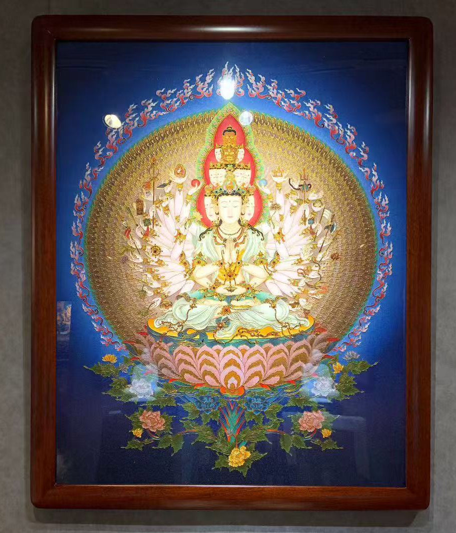 Close-up detail of a Rebgong gemstone pigment thangka showing Thousand-Armed Avalokiteshvara, highlighting hand-painted line work, mineral pigments from lapis lazuli, malachite, cinnabar, and traditional Himalayan craftsmanship