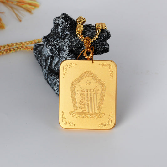Back view of the Rebgong Gold Thangka pendant showing a matte gold-tone copper case with engraved Buddhist motifs and clean handcrafted finish.