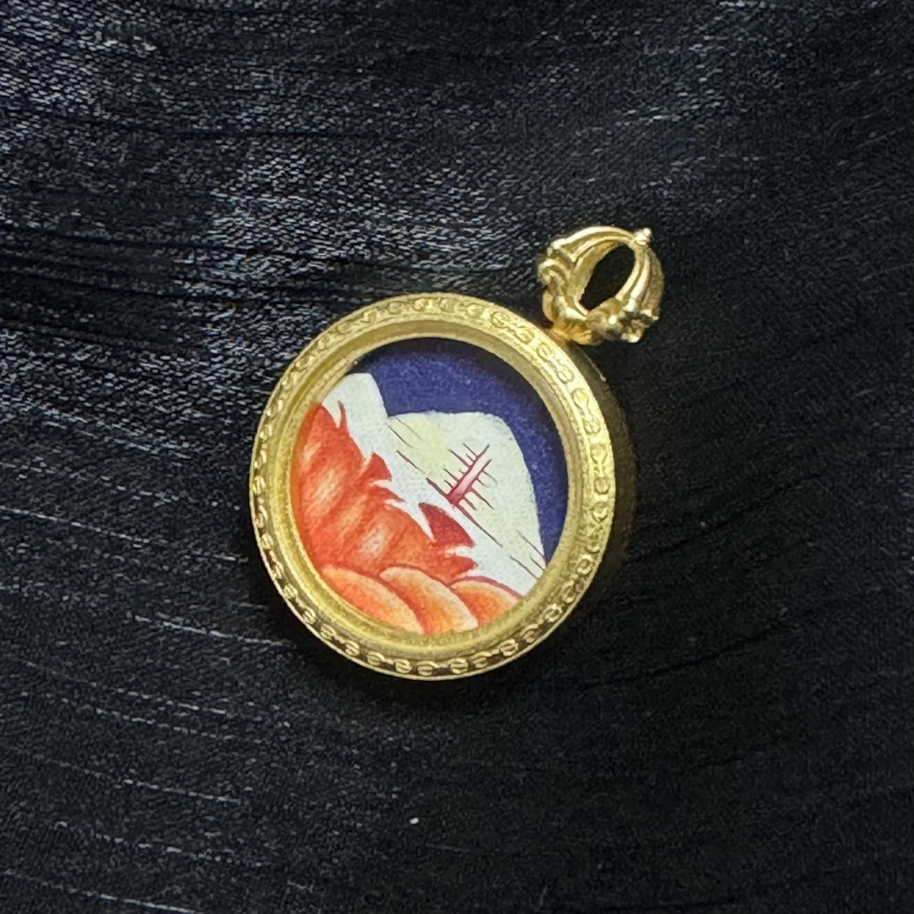 Angled view of Rebgong hand-painted Mount Kailash mini thangka pendant, copper frame thickness, textured mountain brushwork and layered mineral pigment colors