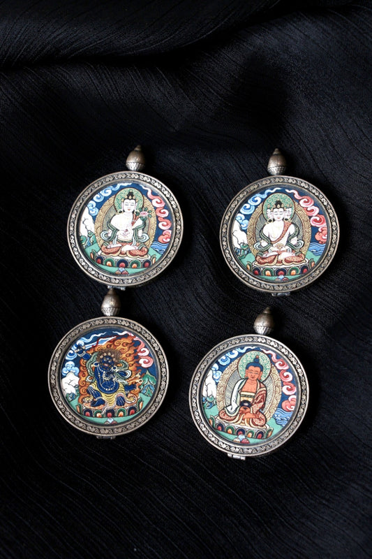 Collection of Rebgong hand-painted thangka pendants, featuring Mahasthamaprapta Bodhisattva alongside other Buddhist deities, each set in round 925 silver frames