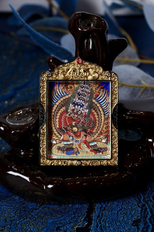 Front view of Maha Heruka thangka pendant, hand-painted with mineral pigments, set in a black-gold copper gawu frame, Rebgong Tibetan art