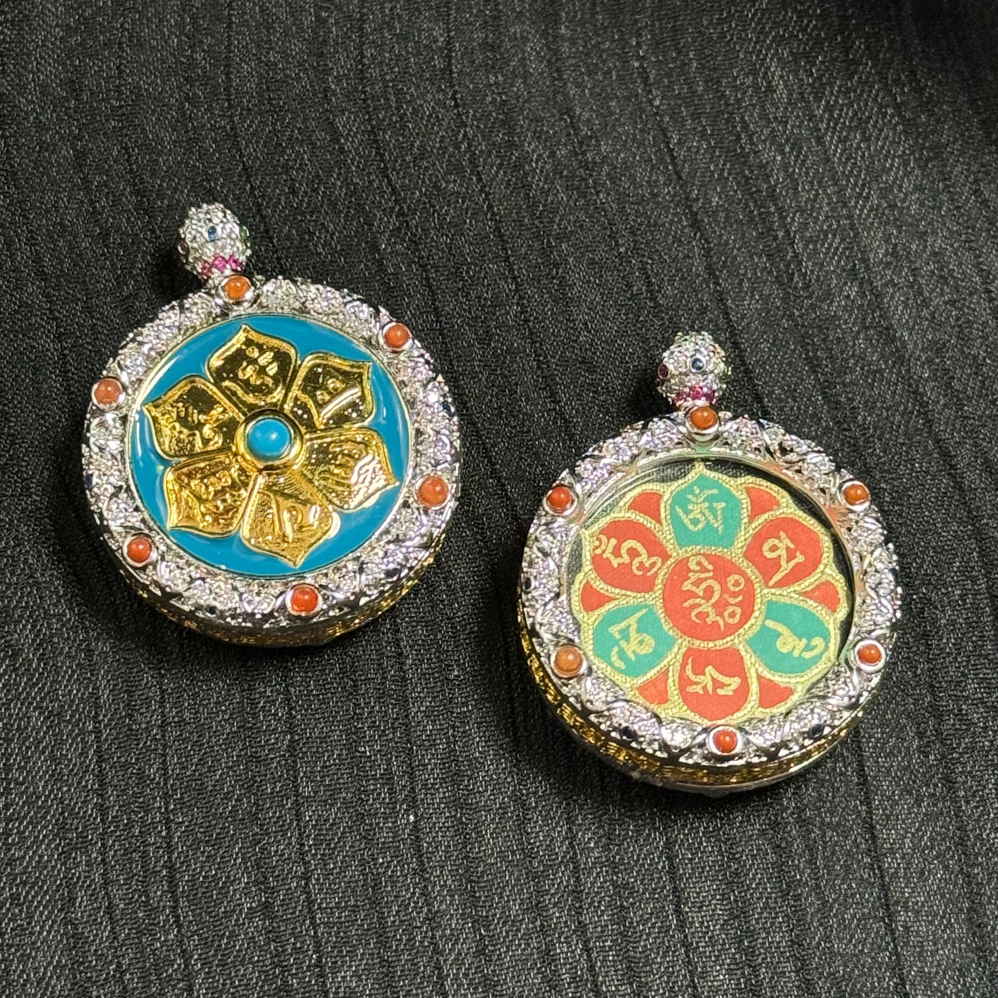Detailed view of the Rebgong-style miniature thangka pendant featuring mineral pigment lotus petals with gold Tibetan mantra writing and decorative gemstone copper frame.
