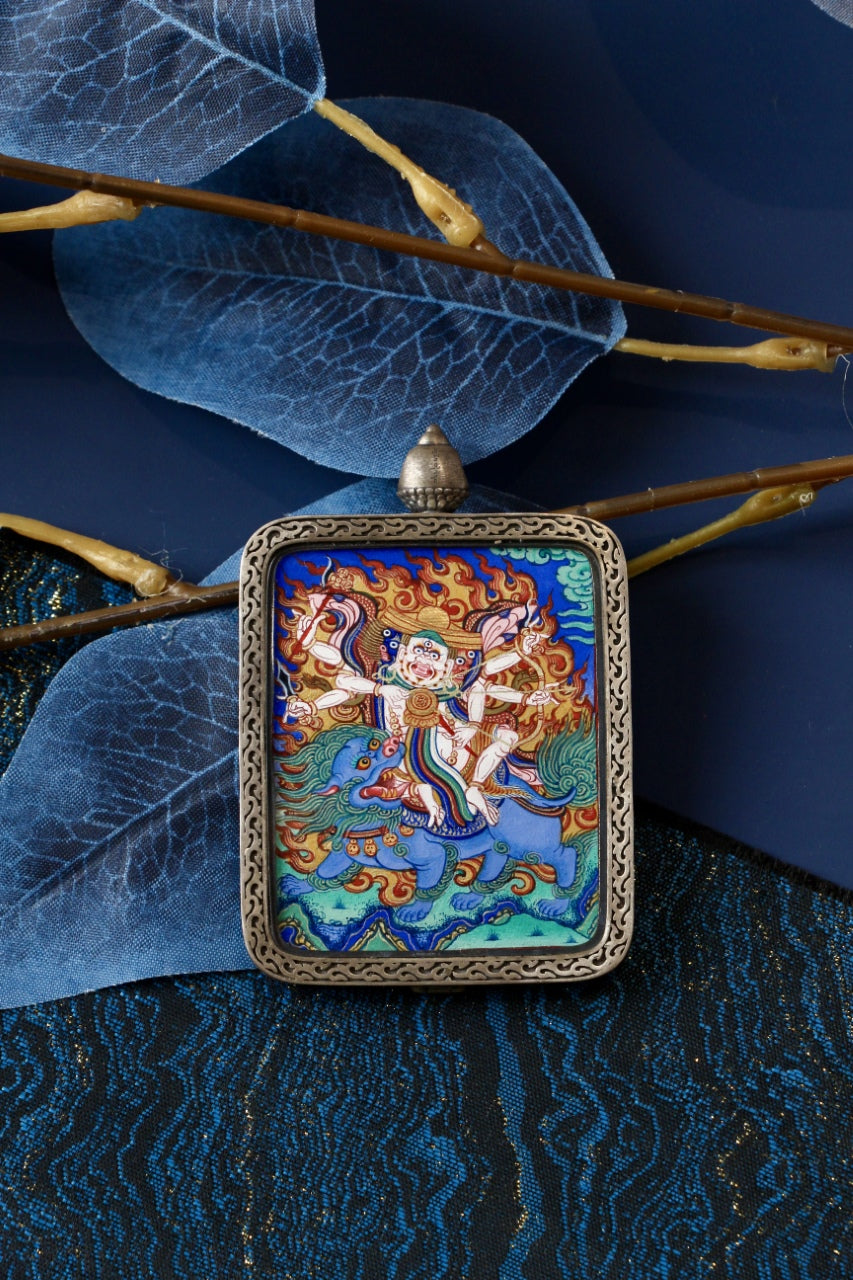 Close-up view of Pehar Gyalpo protector deity mini thangka, painted with mineral pigments in Rebgong Amdo style