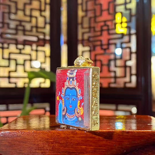 Side view of gold-plated copper Tibetan Gawu box containing a hand-painted Akashagarbha Bodhisattva red thangka pendant