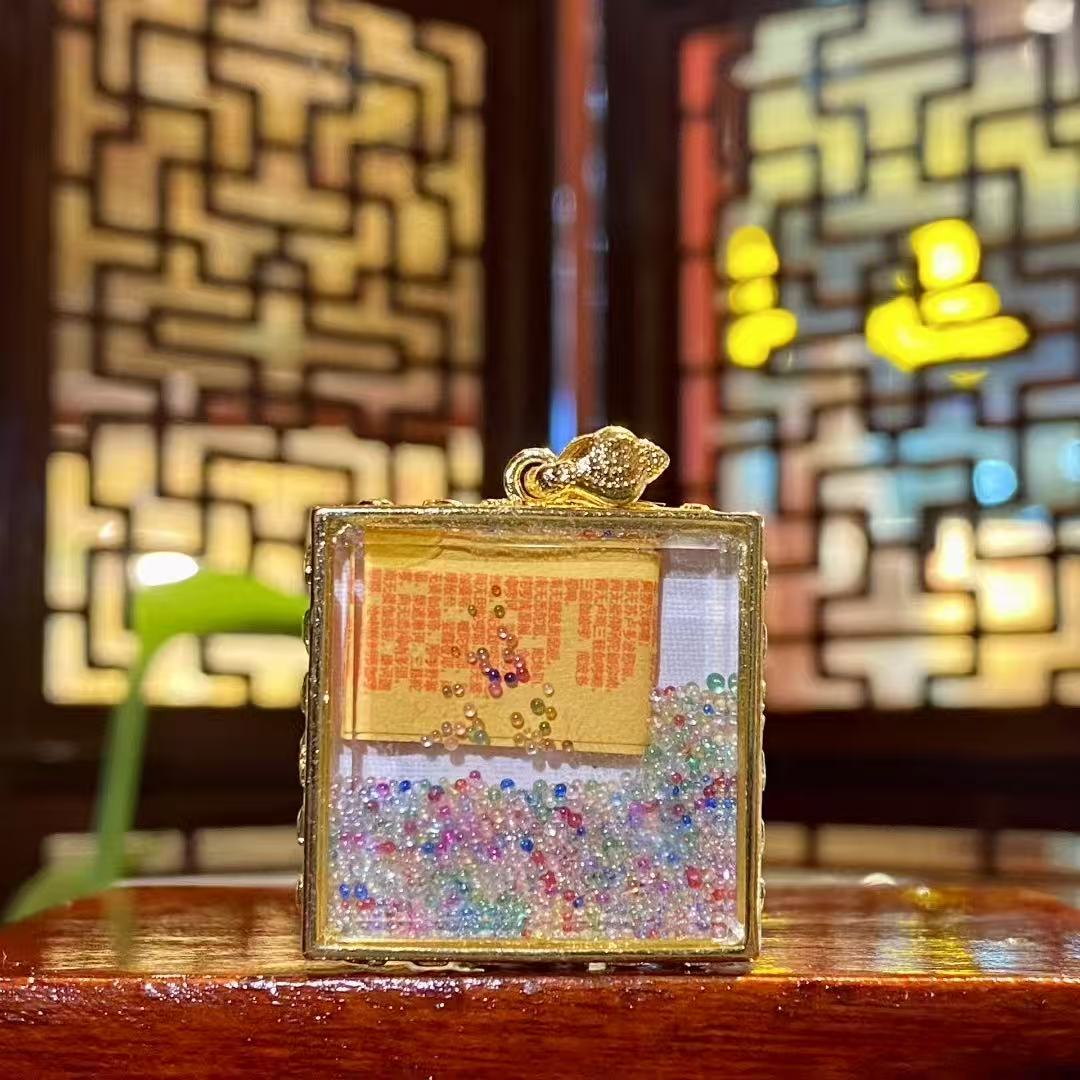 Back view of Samantabhadra Bodhisattva mini thangka pendant with seven treasures glass bead inside the Tibetan Gawu box