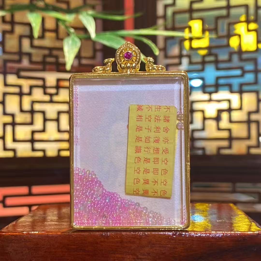 Back view of Samantabhadra Bodhisattva mini thangka pendant revealing traditional inner elements inside a gold-plated Tibetan Gawu box