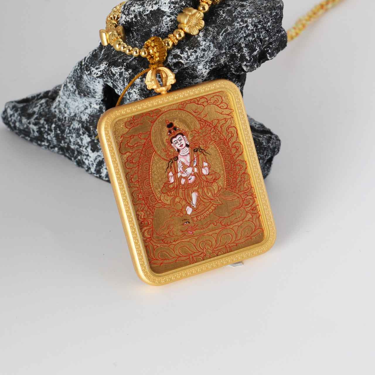 Close-up of a Samantabhadra Bodhisattva mini thangka pendant showing the braided cord, decorative metal beads, and handcrafted hanging structure designed for portable thangka use.