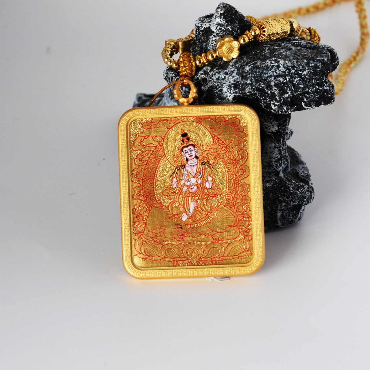 Front view of a Samantabhadra Bodhisattva mini thangka pendant, hand-painted in Rebgong gold thangka style with mineral pigments, featuring fine red line work, gold-ground background, and a copper outer case
