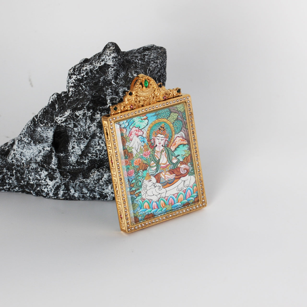 Side-angled standing shot of a Samantabhadra Bodhisattva thangka pendant in a jeweled titanium steel case, highlighting depth and craftsmanship.
