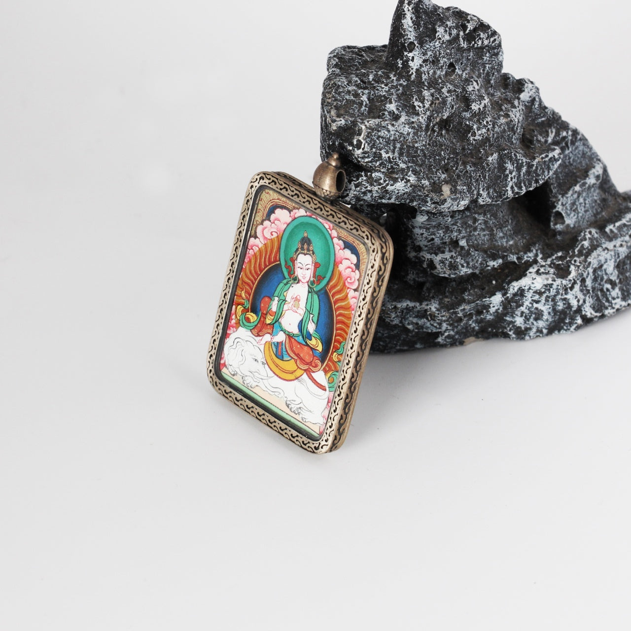 Side view of the Samantabhadra Bodhisattva mini Thangka pendant, showing the silver gawu-style pendant loop, handcrafted metal detailing, and the framed hand-painted Thangka artwork.