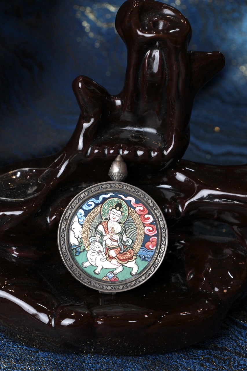 Round thangka pendant depicting Samantabhadra Bodhisattva riding a white elephant, painted in Rebgong cloud-background style and set in a 925 silver frame