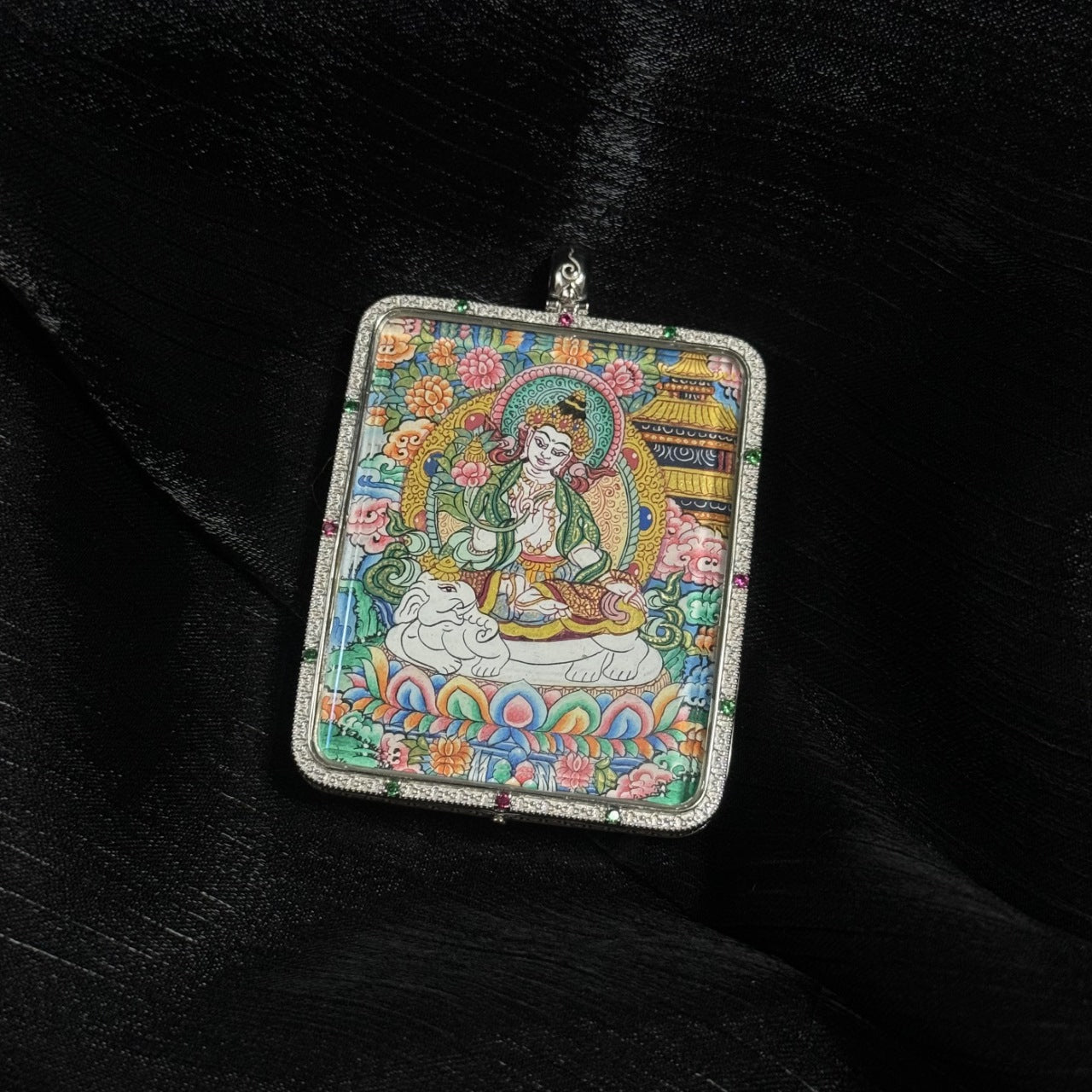 Angled view of Samantabhadra Bodhisattva mini thangka pendant highlighting the intricate mineral pigment painting, colorful lotus base, and decorative gemstone pendant frame.