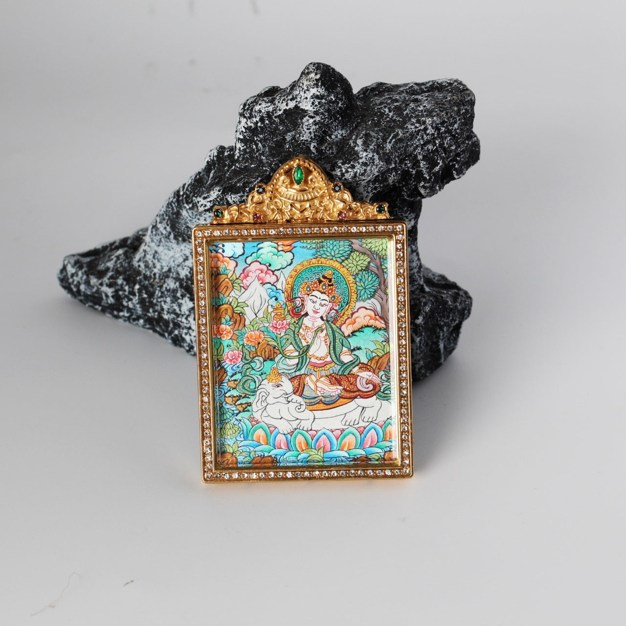 Front view of a Nepal premium color thangka pendant featuring Samantabhadra Bodhisattva on a white elephant, in a jeweled gold-tone titanium steel case.