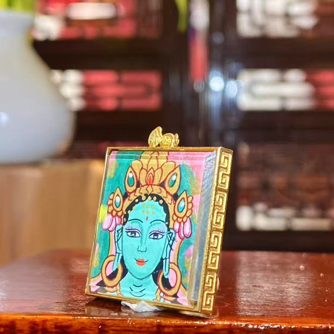 Side view of a double-sided hand-painted Green Tara thangka