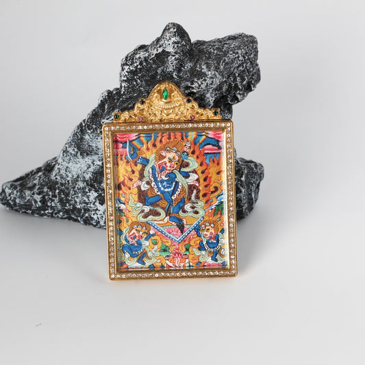 Front view of Simhamukha Dakini mini thangka pendant, fully hand-painted with mineral pigments, framed in a gold-tone titanium steel case with decorative detailing