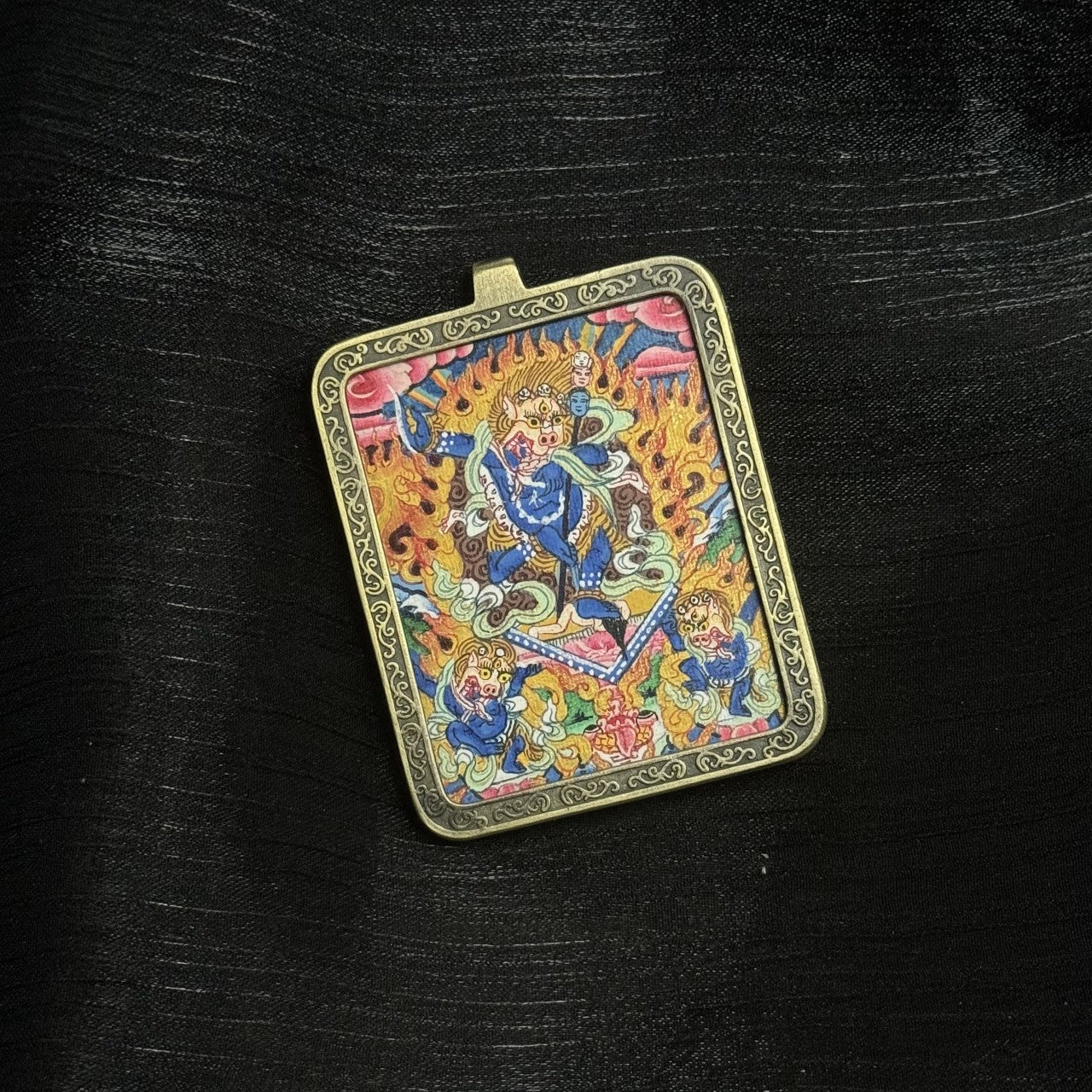 Simhamukha Dakini wrathful protector thangka painting with lion face, dancing posture, ritual implements and surrounding flames, set in a decorative copper pendant frame