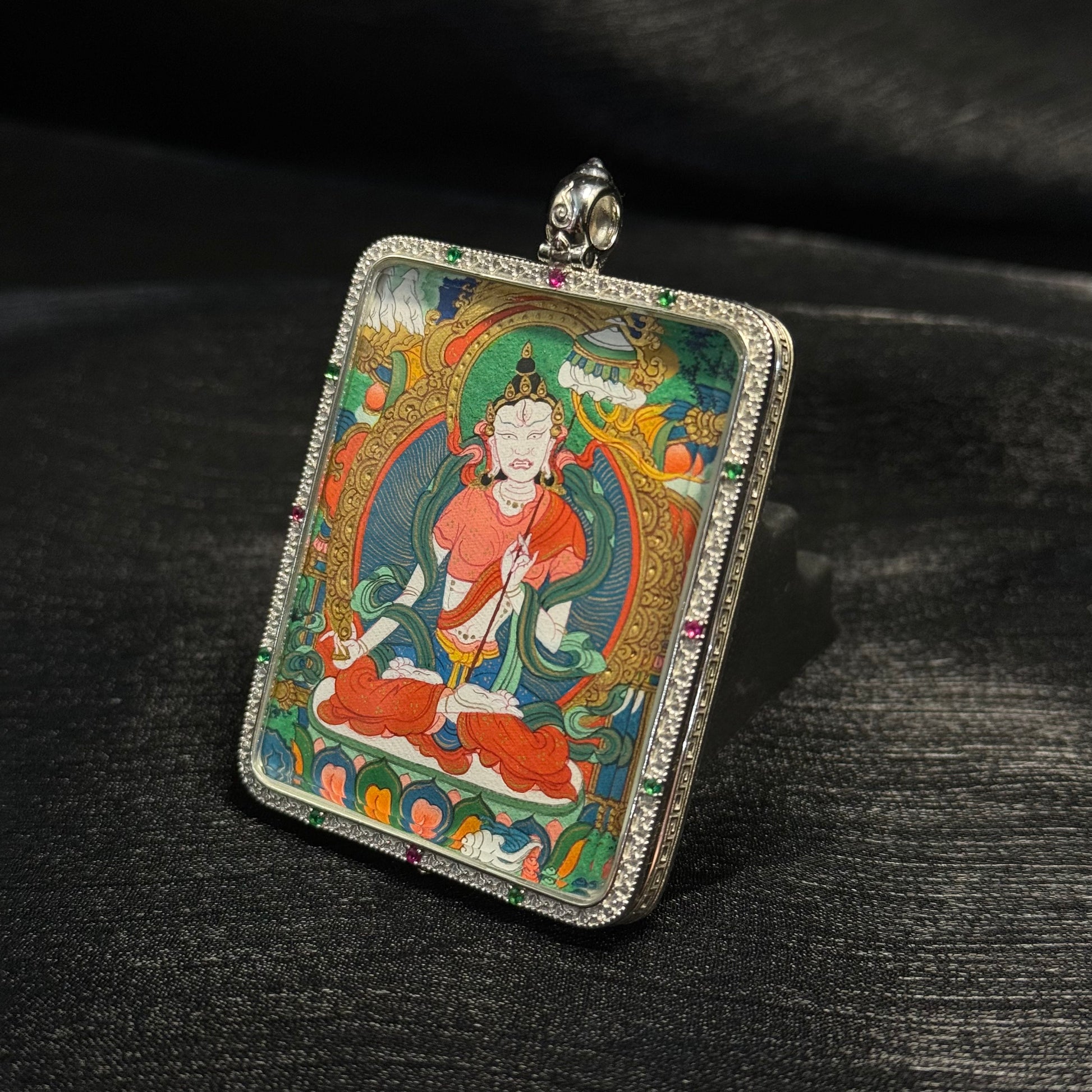 Close angled view of Sitatapatra mini thangka pendant highlighting refined Tibetan linework, layered mineral pigments, and detailed gold painted elements.