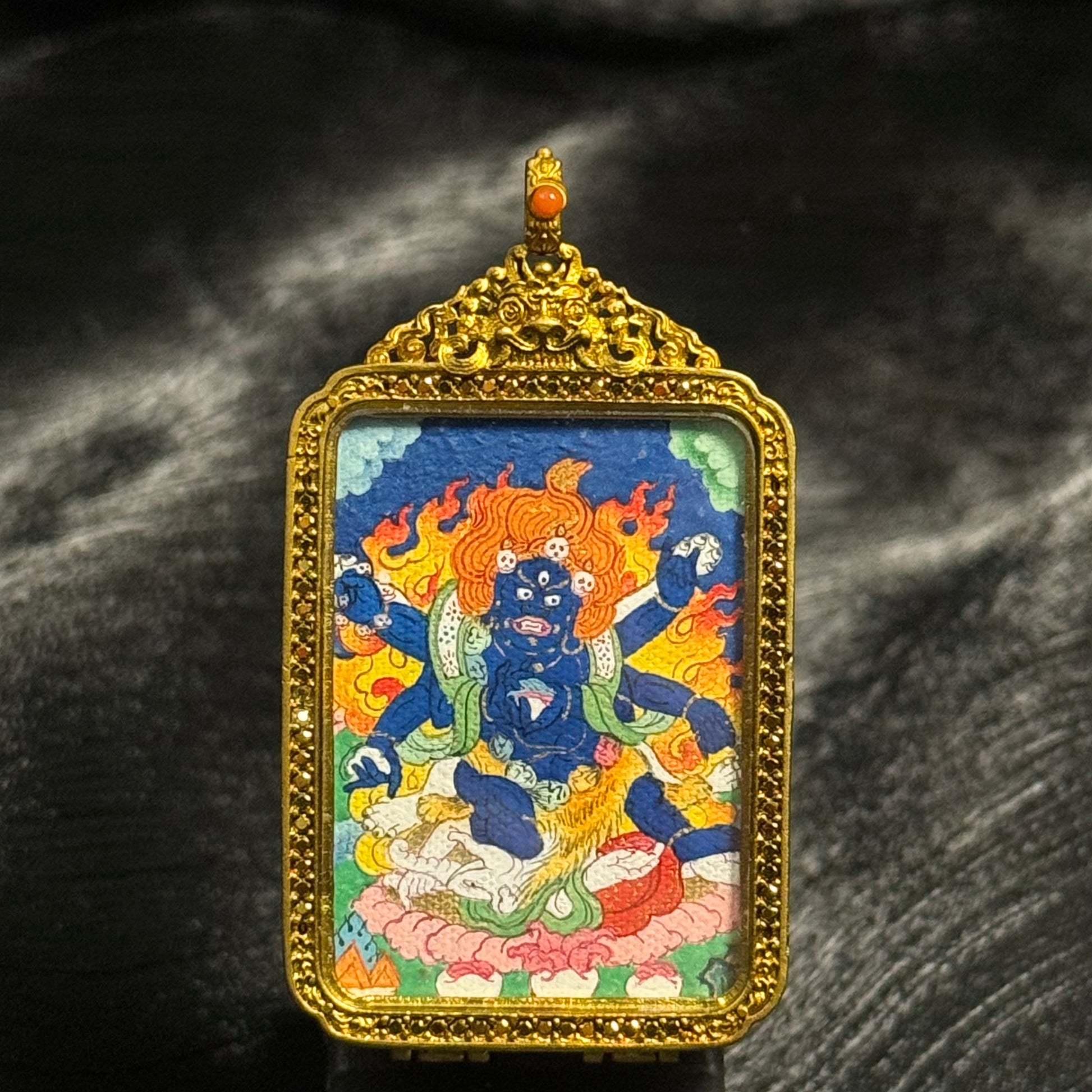 Front view of Six-Armed Mahakala mini thangka pendant, hand-painted with mineral pigments inside an ornate copper protective case, Tibetan Buddhist art detail