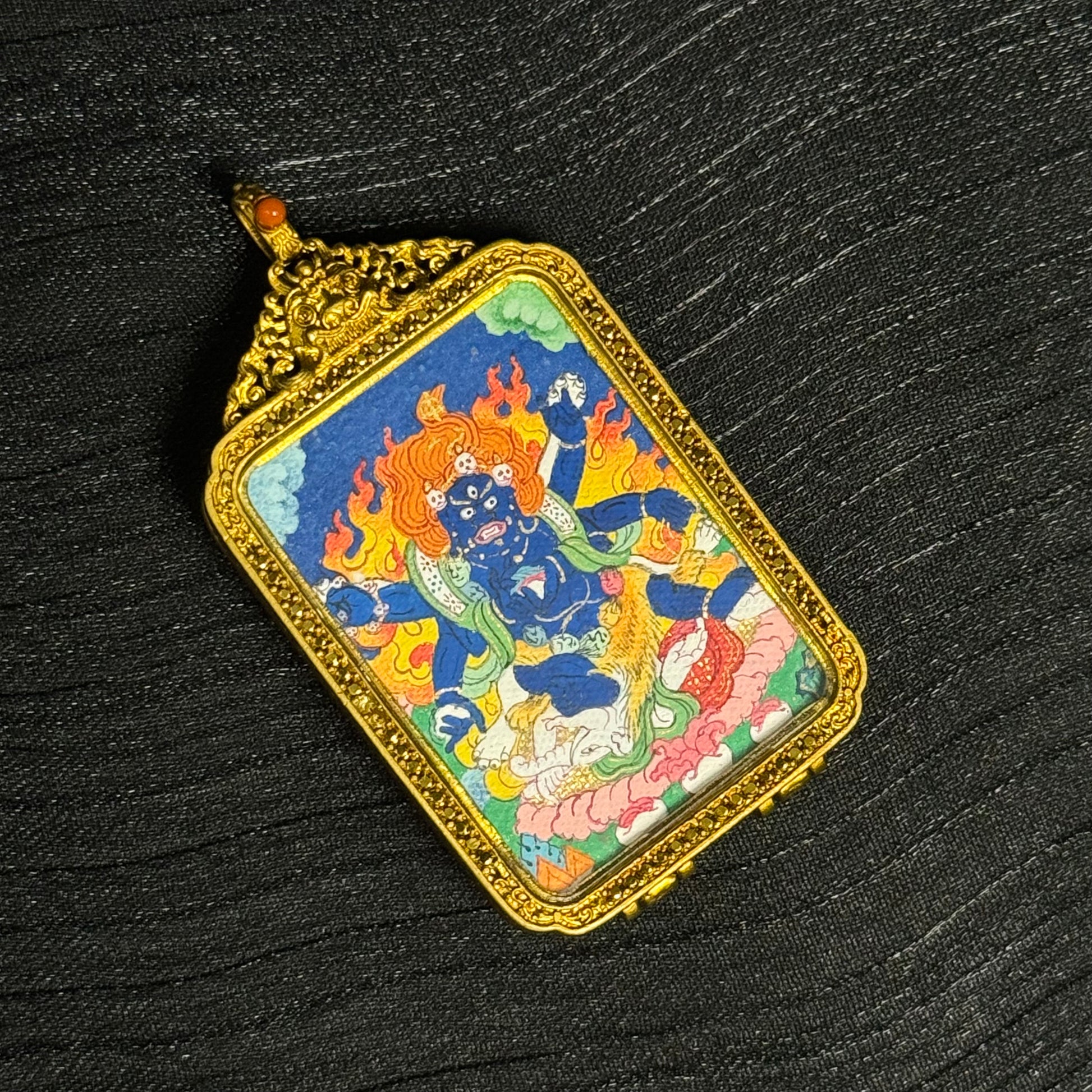 Detailed view of hand-painted Six-Armed Mahakala protector deity miniature thangka pendant in ornate copper case