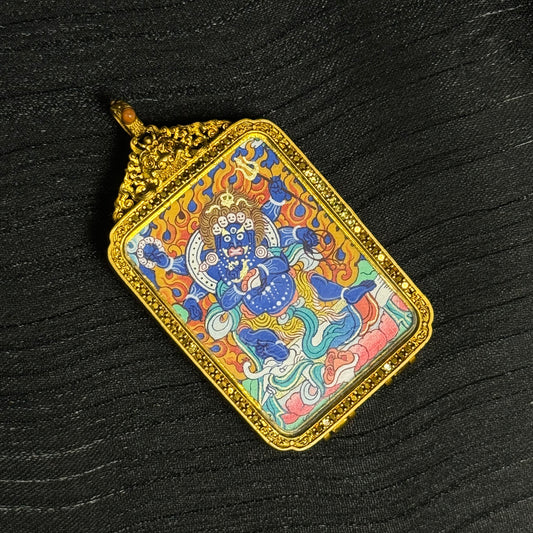 Angled view of hand-painted Six-Armed Mahakala miniature thangka pendant showing detailed mineral pigment painting and ornate Tibetan copper frame