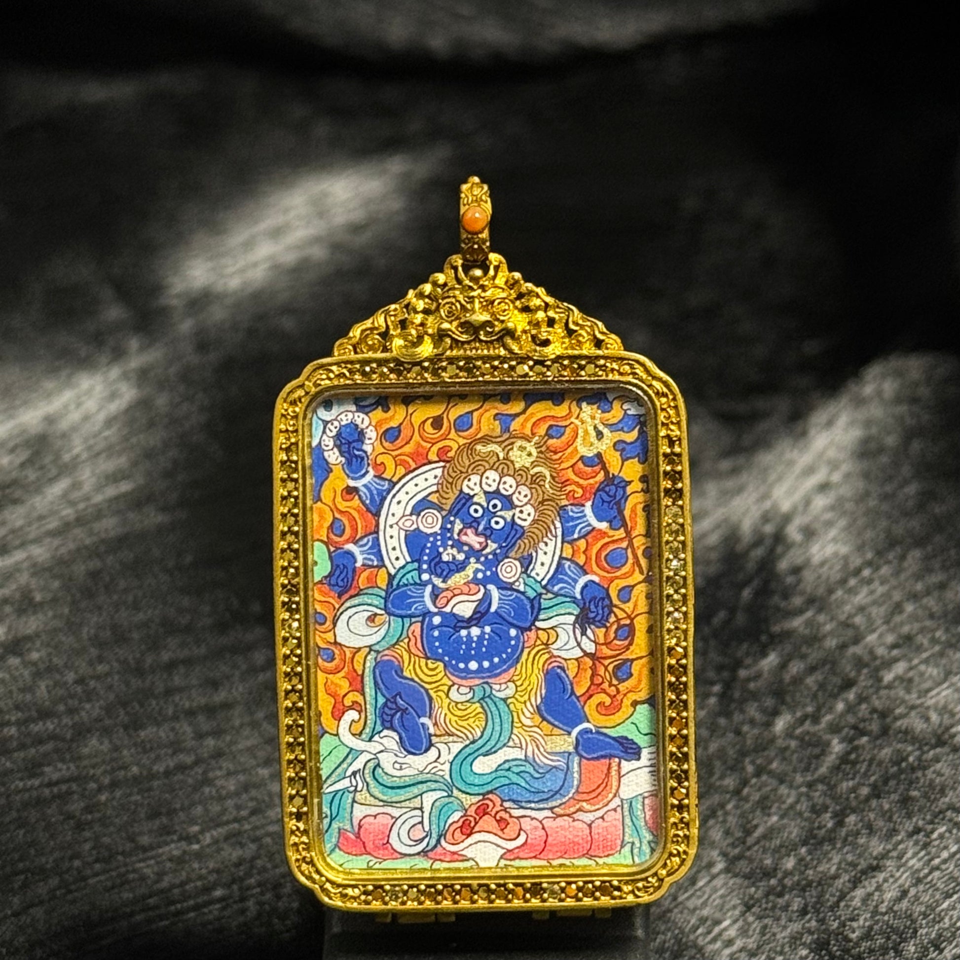 Front view of Six-Armed Mahakala mini thangka pendant from Rebgong tradition, hand-painted with mineral pigments inside an ornate copper protective case