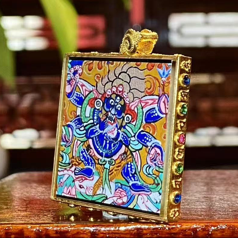 Side view of Six-Armed Mahakala Tibetan Gau pendant showing metal casing and sapphire crystal protective cover
