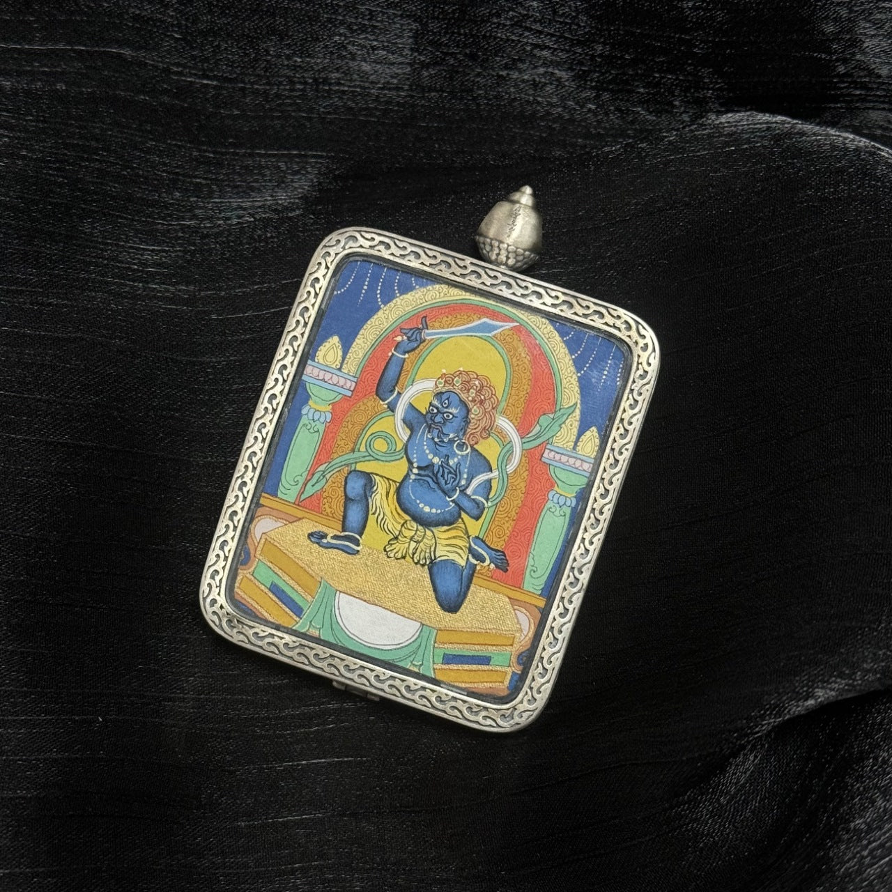 Square Acalanatha mini Thangka pendant in ornate silver frame crafted in Tibet