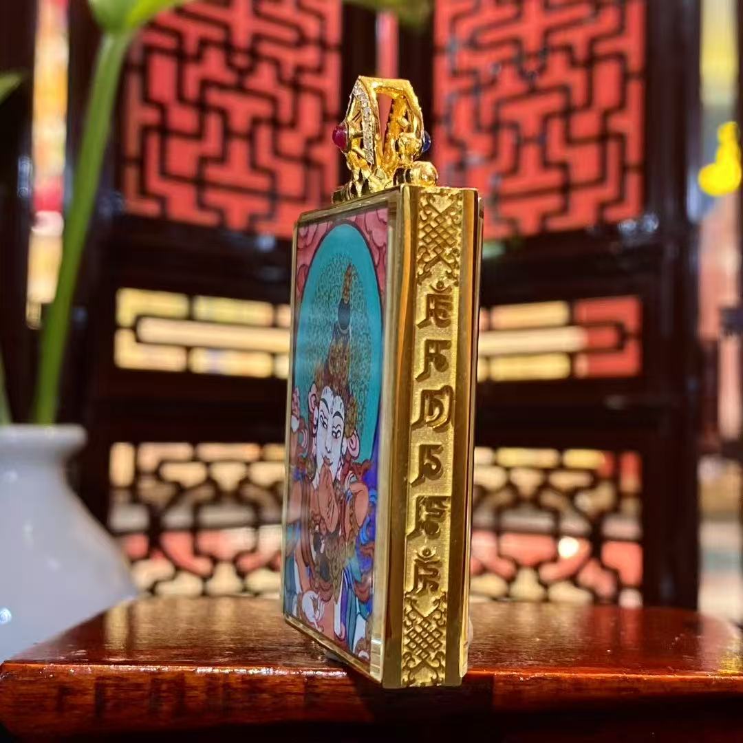 Side view of an 18K gold Tibetan gau box pendant featuring a double-sided Rebgong hand-painted thangka with dual sapphire crystal mirrors, showing refined metal craftsmanship and compact portable design