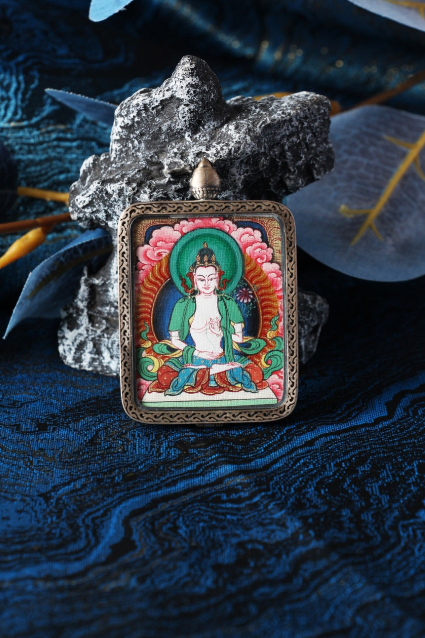 Mahasthamaprapta Bodhisattva mini thangka pendant displayed in a Tibetan-inspired setting, hand-painted using traditional mineral pigments
